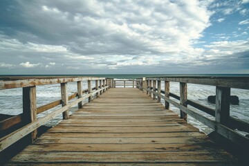 Obraz premium Tranquil vintage wooden pier overlooking calm waters scenic coastal location high-resolution image serene atmosphere wide-angle perspective