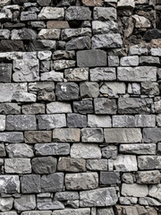 Fototapeta premium Old brown rock stone wall with rough texture pattern