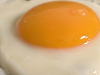 Close-up of a perfectly cooked fried egg with bright yolk