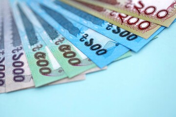 Obraz premium Bangladeshi taka money bills in big amount lies on teal color table close up