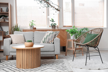 Comfortable armchair, sofa and table in living room