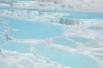 Natural travertines pools with blue water in Pamukkale
