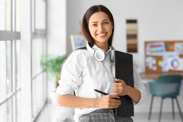 Female interior designer with graphic tablet in office