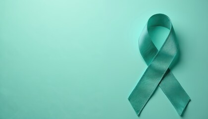 Teal ribbon on teal background symbolizes ovarian, cervical cancer awareness. Awareness ribbon, world cancer day, medical concept. Health, hope, support, prevention.