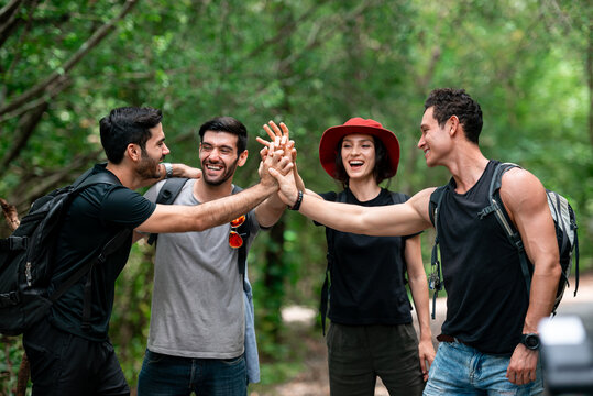 Group of Diverse Friends Celebrate Hiking Success Together in Scenic Forest Trail During Active Summer Vacation Adventure