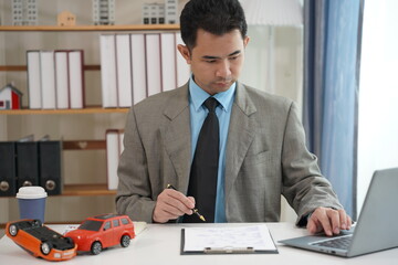 Insurance agent is calculating car insurance. Businessman is signing car insurance contract or...