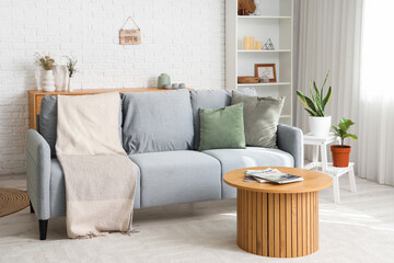 Interior of light living room with sofa and coffee table