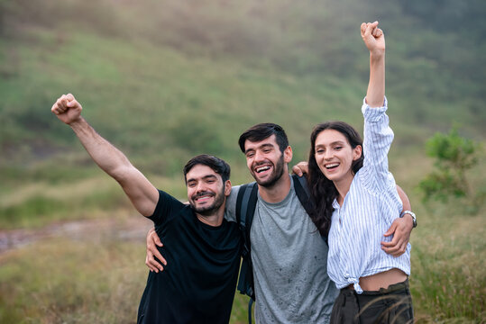 Adventure Group of Diverse Friends Hiking in Scenic Forest and Celebrating Teamwork Success on Active Summer Vacation - Powered by Adobe