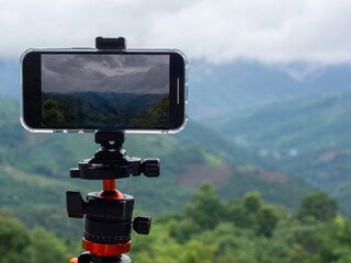 Behind the scenes at a tourist attraction - a camera or smartphone mounted on a tripod captures the...