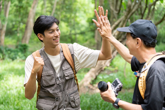 Father and Son Celebrating Hiking Success with a High Five