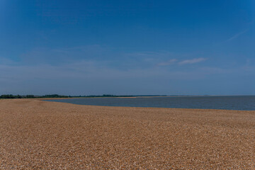 Blue skies over the beach at Shingle Street in Suffolk, UK