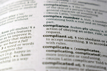 Close Up Of English Dictionary Page With Word -  Compliance