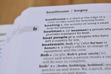 Close Up Of English Dictionary Page With Word - Boat People