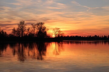 Fototapeta premium Sunset reflections over a quiet l