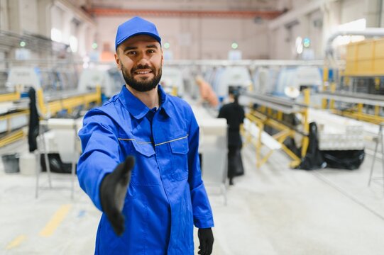 Factory worker offering handshake in window and door manufacturing plant