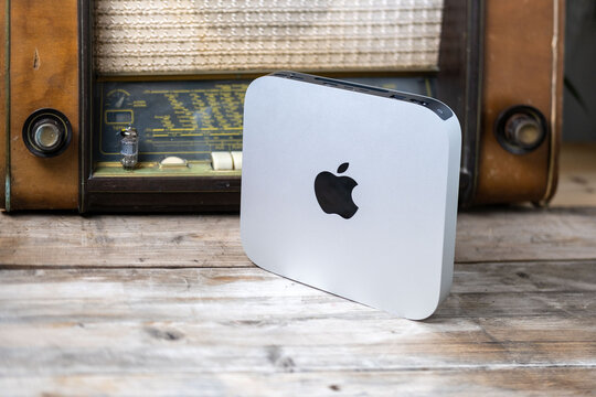 Mac Mini M1 Apple computer held, retro radio, old and new technology portability, vintage aesthetic, working remotely in cozy home environment, Frankfurt - February 4, 2025