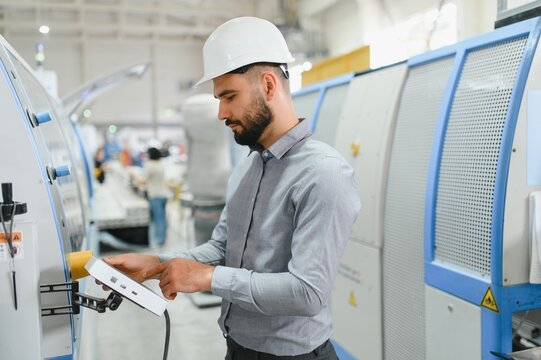Industrial engineer operating machinery in modern factory setting - Powered by Adobe