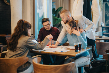 Group of individuals working together in a relaxed setting, brainstorming ideas and strategies....
