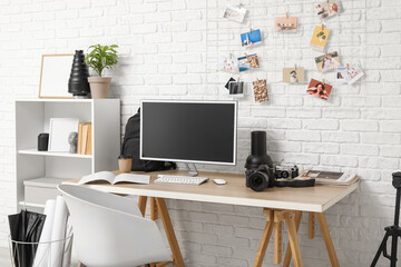 Interior of office with photographer's workplace and shelf unit