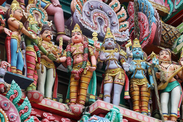 Intricate Hindu temple sculpture depicting divine wedding, likely Shiva and Parvati marriage,...