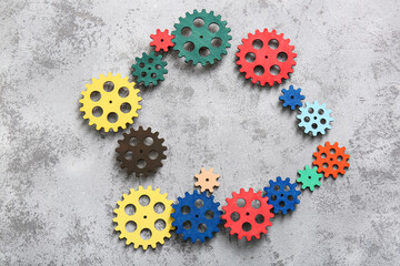 Frame made of wooden gears on grunge background
