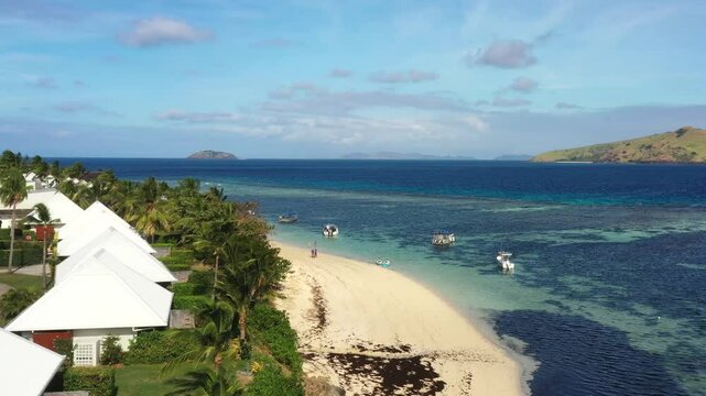 Floating boats at beach of Tokoriki island tourist resort tropical coral reefs in Fiji.
