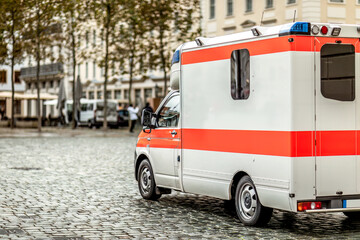 Emergency ambulance vehicle in urban European city street
