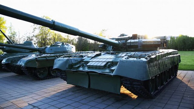 Monuments to modernized T-72 tanks against the backdrop of the setting sun.