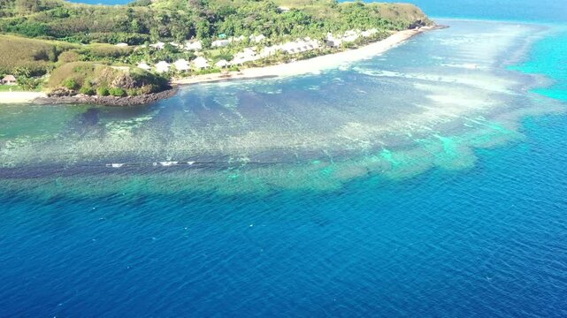 Coral reefs sea surface to blue sky at Tokoriki island resort in Fiji, Pacific islands.
