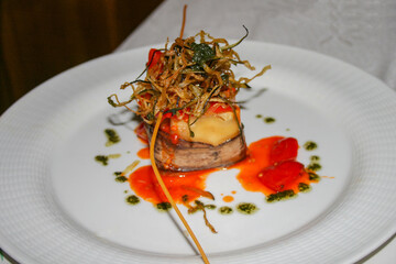 An elegant appetizer of vegetables with cheese and tomato sauce.