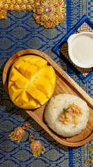 Golden mango whispers sweetness beside coconut-kissed sticky rice on opulent Thai silk, tempting Songkran and exotic taste pilgrimages
