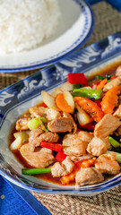 Stir-fried symphony of vibrant vegetables and succulent chicken evokes Lunar New Year feast, tantalizing spice harmony on porcelain