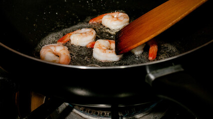 Golden shrimp sizzle in bubbling butter, reminiscent of Carnival feasts, savoring Mardi Gras indulgences with a sizzling twist