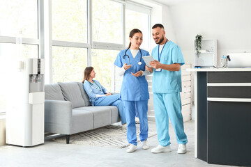 Medical interns working with tablet computer in clinic