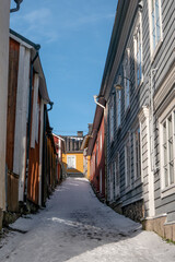 Narrow Snowy Alley with Colorful Wooden Houses in Old Town Porvoo, Finland