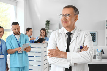 Male doctor against medical interns in clinic