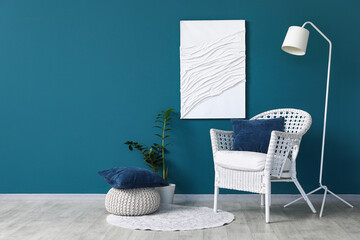 Interior of living room with white armchair, lamp and painting