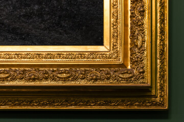 Detailed close-up view of an ornate gold-gilded frame