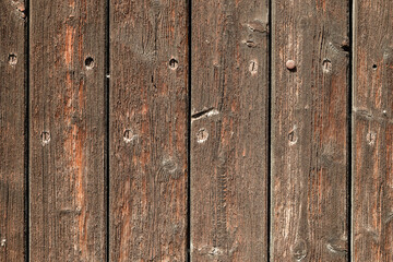 Weathered wooden planks tell stories of time and nature in a rustic setting perfect for...