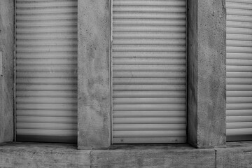 Shuttered windows reveal the texture and patterns of a building in an urban setting during the...