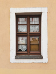 Vintage window with wooden frame and thick glass. Exterior.