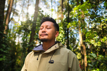 Man Relaxing in Forest With Sunlight Passing Through Trees