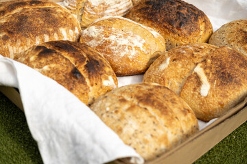 Artisan sourdough homemade craft bread on white textile background. Natural light with soft shadows, close-up top view