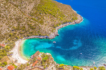 Aerial view of Dubovica Beach on Hvar Island, Croatia, showcasing its dramatic rocky coastline, crystal-clear turquoise waters, and secluded coves surrounded by untouched Mediterranean nature