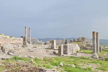 Panoramic View of Ancient Roman City of Dougga, Tunisia &ndash; Well-Preserved Roman Ruins Under Cloudy Sky