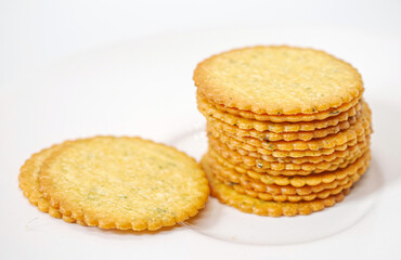 Thin round biscuits crackers stacked together close-up, Sweet and tasty round butter crackers.