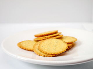 Thin round biscuits crackers stacked together close-up, Sweet and tasty round butter crackers.