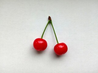 Two cherry berries on paper background