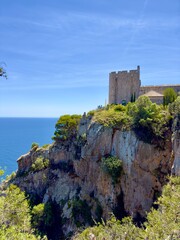 spectacular view towards the public Torre de Guaita de Sant Sebastia de la Guarda tower on high cliffs at the Mediterranean Sea near Llfranc, Costa Brava, Girona, Catalonia, Spain