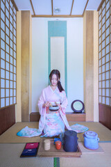 Young Asian Japanese woman in a Traditional Yukata Dress. Asian girl wearing a beautiful pink...